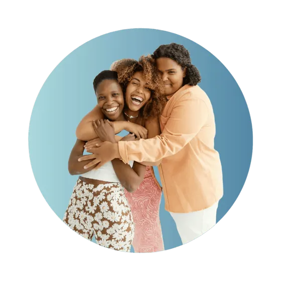 Three women smiling and embracing at a Spher first meet